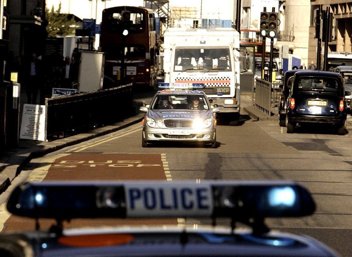 British metropolitan police vehicles escorting Iraqi Bilal Abdulla and Jordanian Mohammed Asha arrive 05 October 2007 outside London's criminal court prior to their trial for their suspected involvement in three failed car bombings in London and Glasgow last June. AFP PHOTO/SHAUN CURRY (Photo credit should read SHAUN CURRY/AFP/Getty Images)